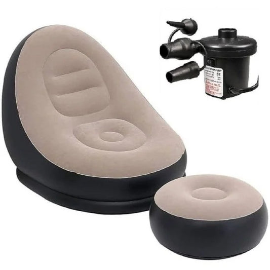 An inflatable black and beige two-piece lounge set, including a high-back chair and a matching round ottoman, shown with an electric air pump in the upper right against a plain white background.
