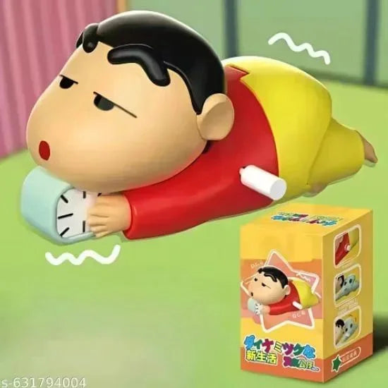 A plastic wind-up toy of the character Crayon Shin-chan lying on his stomach holding a small clock, displayed next to its yellow retail packaging box.