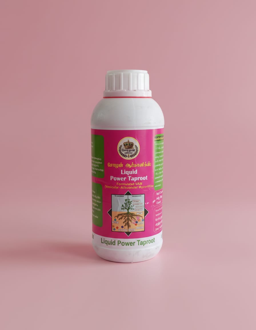 A white plastic bottle of Cholan Organics Liquid Power Taproot, featuring a bright pink and green label with English and Tamil text alongside a diagram of a plant's root system, set against a solid light pink background.