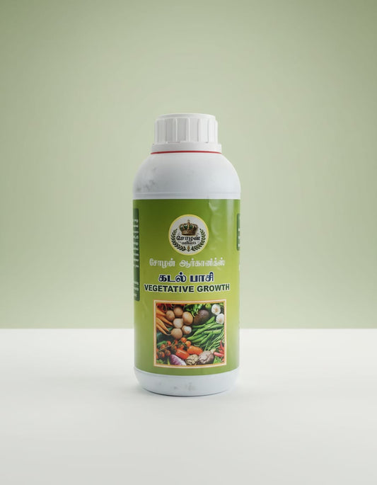 A white plastic bottle of Cholan Organics Seaweed (Kadal Pasi) liquid for Vegetative Growth, featuring a green label with Tamil and English text and a square illustration of mixed fresh vegetables, sitting on a white surface against a light green background.
